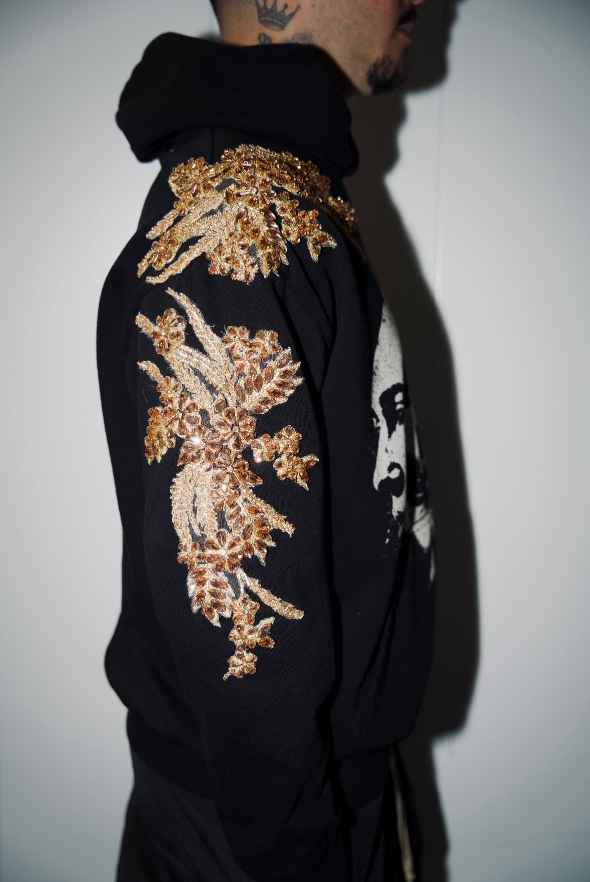 THE GILDED FACES HOODIE.     FEATURING HAND-SEWN GOLD CRYSTAL MOTIFS 1/1